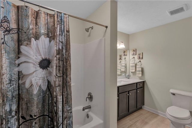 bathroom with shower / bath combo, baseboards, visible vents, toilet, and vanity