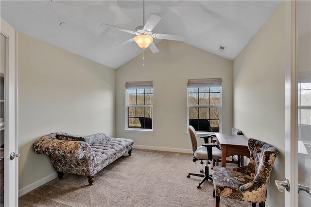 carpeted home office featuring lofted ceiling, visible vents, baseboards, and a ceiling fan