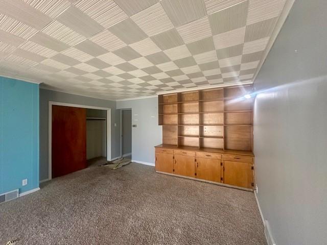 interior space featuring carpet, visible vents, and baseboards