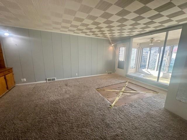 unfurnished room with carpet floors and visible vents