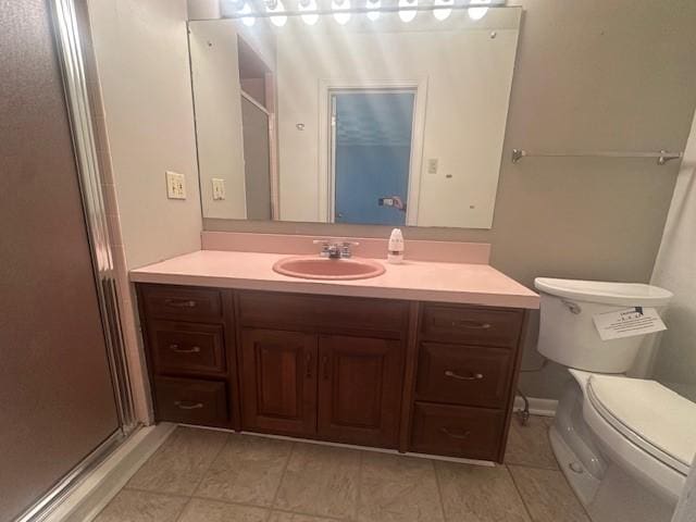 bathroom featuring toilet, a stall shower, tile patterned flooring, and vanity