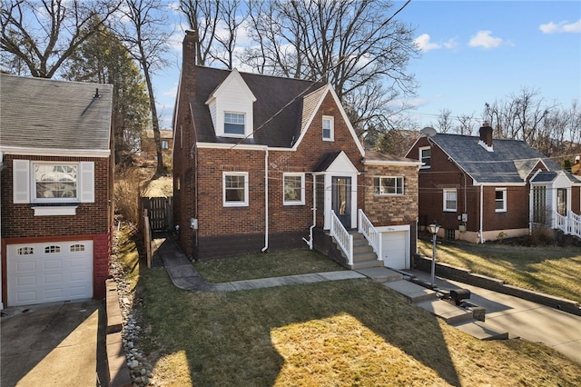 view of front facade featuring a garage, concrete driveway, brick siding, and a front lawn