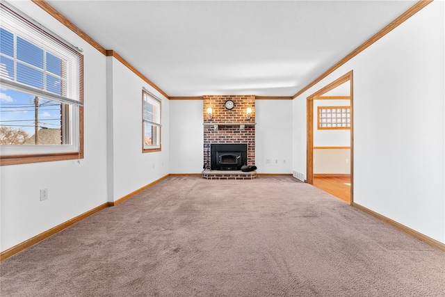 unfurnished living room with carpet, plenty of natural light, a brick fireplace, and ornamental molding