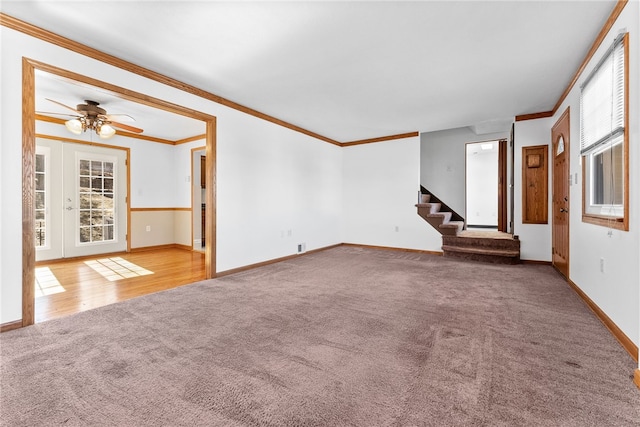 unfurnished living room featuring ornamental molding, carpet, stairway, and baseboards