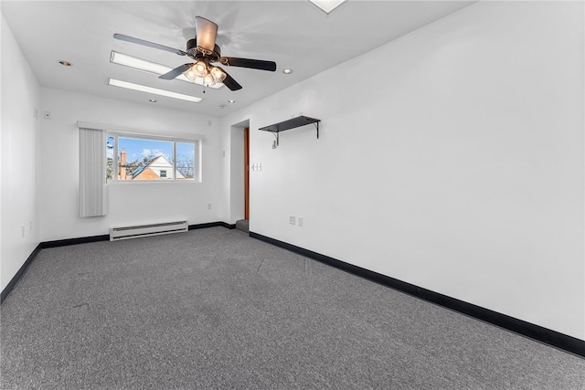 carpeted spare room with a baseboard heating unit, recessed lighting, ceiling fan, and baseboards