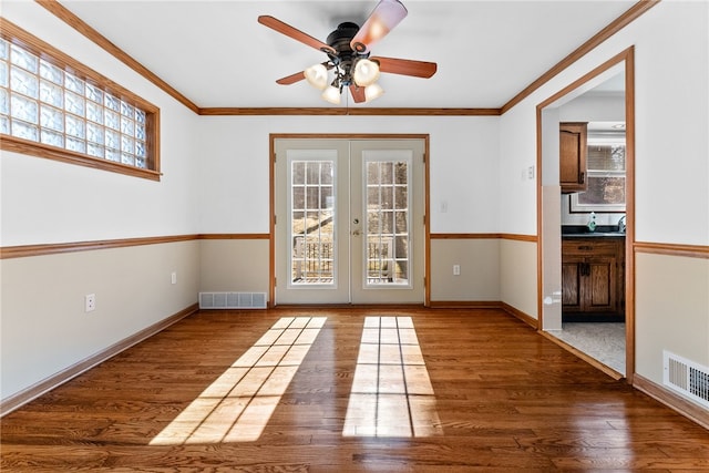 doorway with french doors, visible vents, and wood finished floors