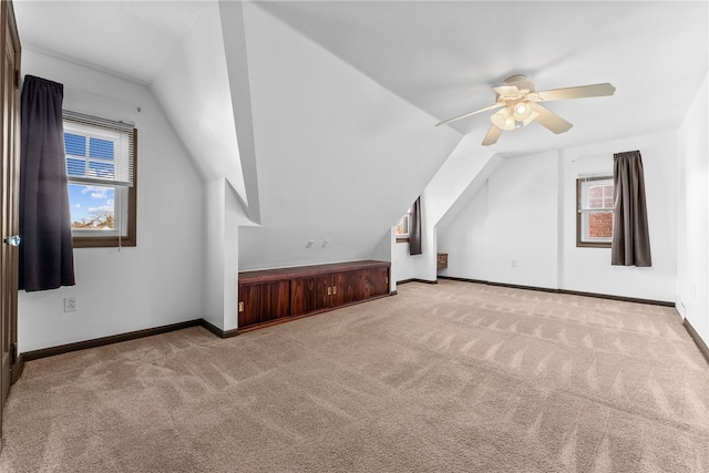 additional living space featuring carpet floors, vaulted ceiling, and baseboards