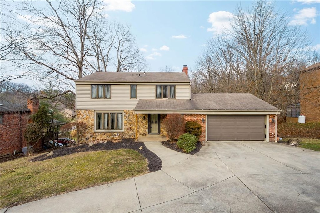 222 Clubview Dr, Peters Twp, PA 15317 - traditional home with concrete driveway, stone siding, a chimney, an attached garage, and a front lawn
