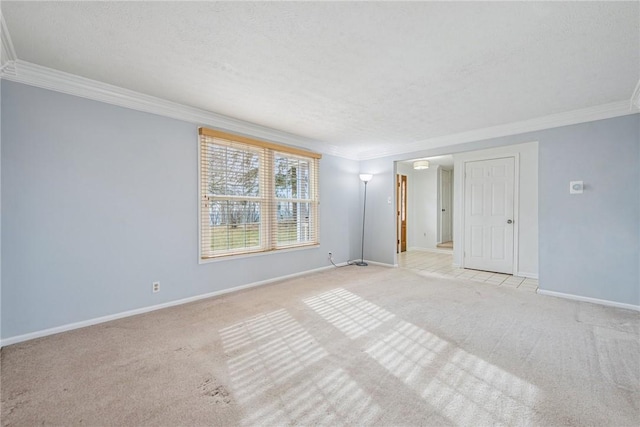 empty room featuring light carpet, baseboards, ornamental molding, and a textured ceiling