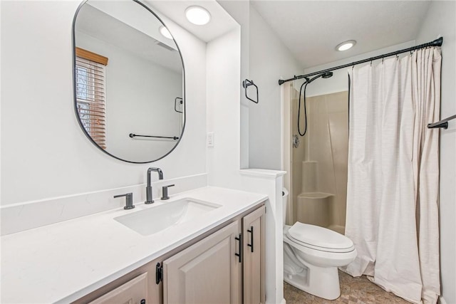 bathroom with curtained shower, vanity, and toilet