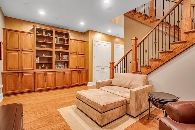 living room featuring light wood-style floors, stairway, and recessed lighting