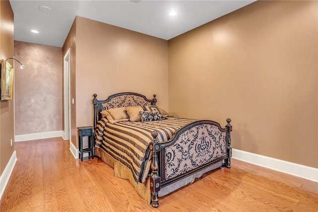 bedroom featuring recessed lighting, wood finished floors, and baseboards