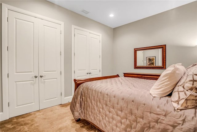 bedroom featuring recessed lighting, visible vents, and light colored carpet