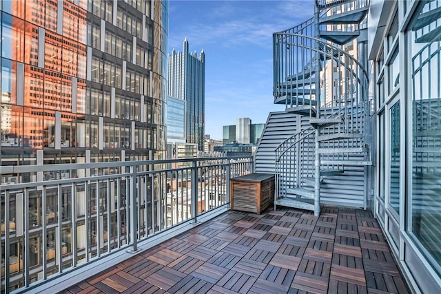 balcony with stairs and a city view