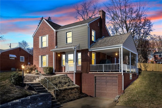 traditional-style home featuring driveway, brick siding, stairway, and an attached garage