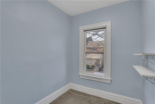 spare room with carpet and baseboards