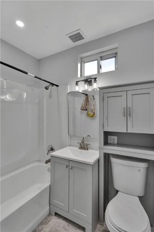 bathroom with toilet, bathing tub / shower combination, vanity, visible vents, and marble finish floor