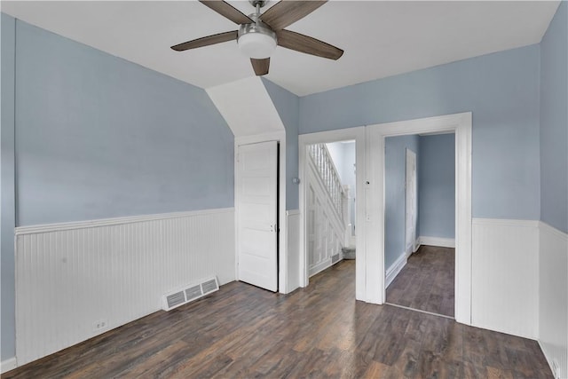 interior space featuring a wainscoted wall, visible vents, and wood finished floors