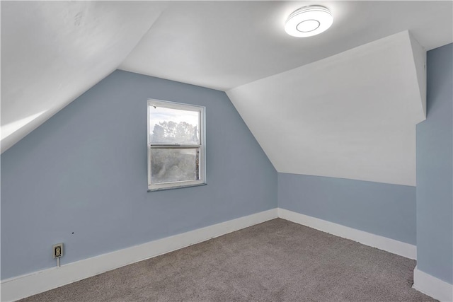 bonus room with carpet floors, baseboards, and vaulted ceiling