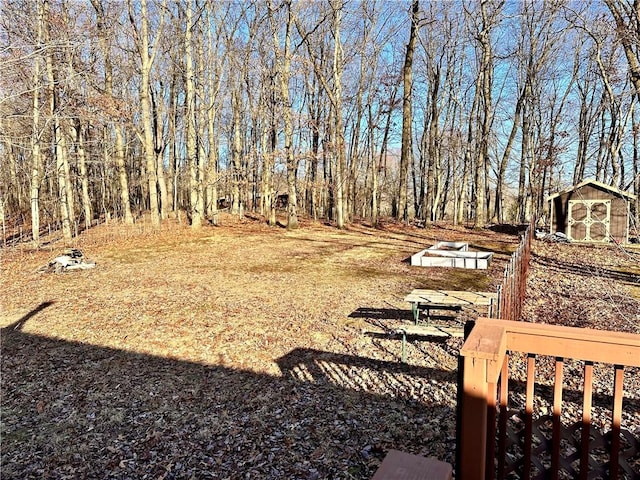 view of yard featuring a storage shed and an outbuilding