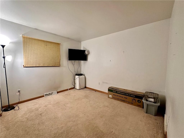 interior space with baseboards, visible vents, and carpet flooring