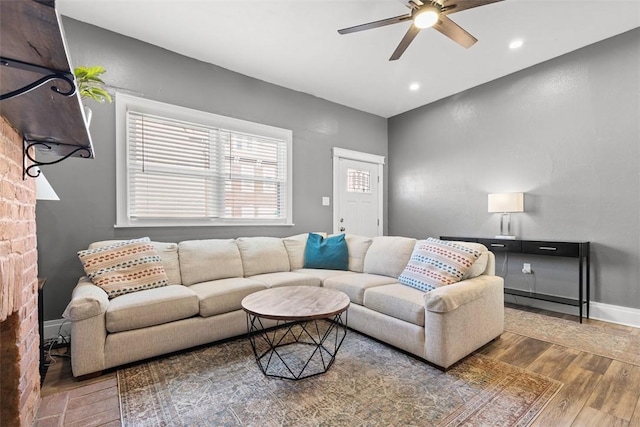 living area with a ceiling fan, recessed lighting, baseboards, and wood finished floors