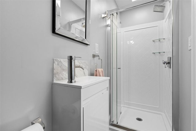 bathroom with toilet, a shower stall, and vanity