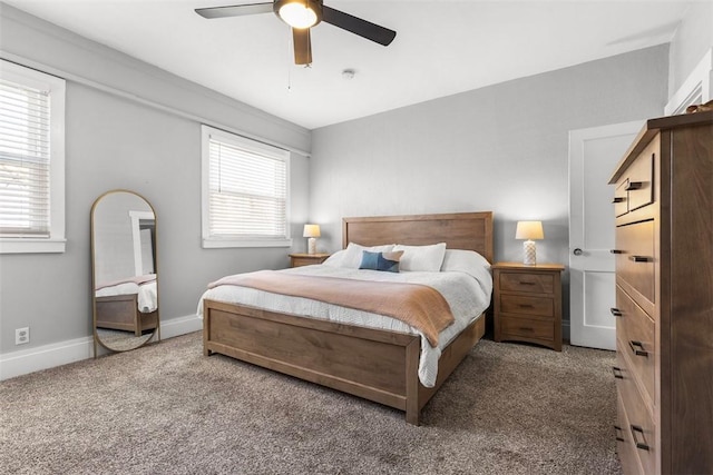 carpeted bedroom with baseboards and a ceiling fan