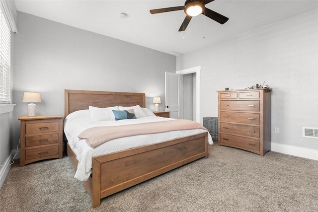 carpeted bedroom with baseboards, visible vents, and ceiling fan