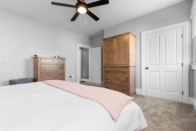 bedroom with baseboards, visible vents, ceiling fan, and carpet flooring