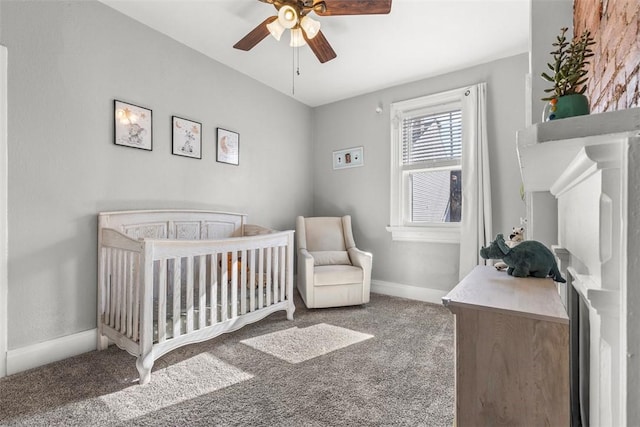 bedroom featuring a nursery area, carpet flooring, ceiling fan, and baseboards