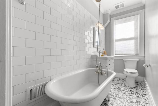 bathroom with toilet, tile patterned flooring, a freestanding tub, and visible vents