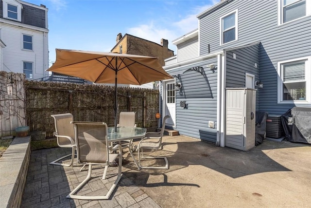 view of patio featuring fence and outdoor dining area