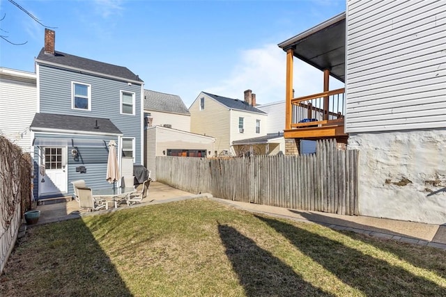 view of yard featuring fence and a patio