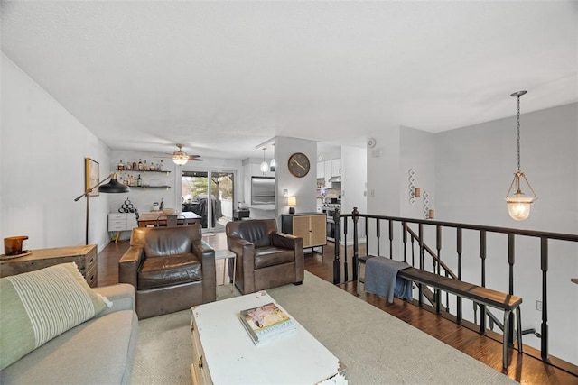 living room with wood finished floors and a ceiling fan