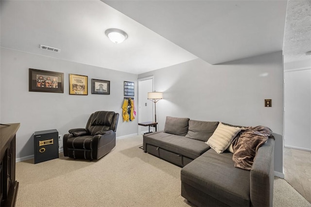 living room featuring carpet floors, visible vents, and baseboards