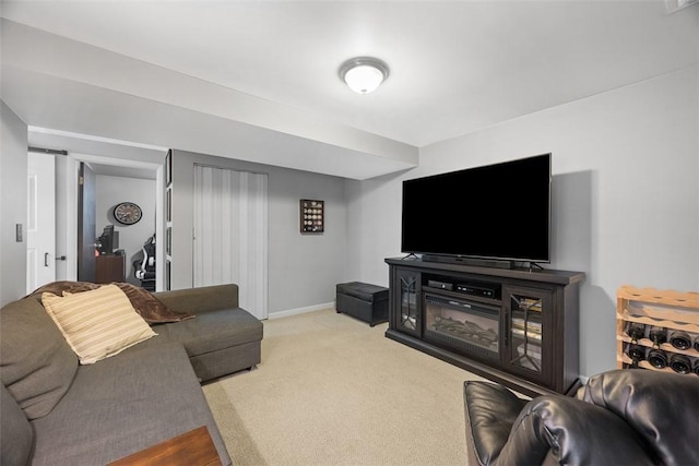 carpeted living area featuring baseboards