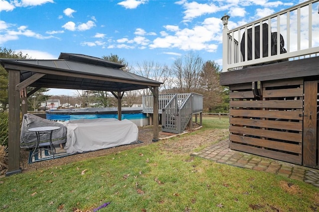 view of yard featuring an outdoor pool and a gazebo