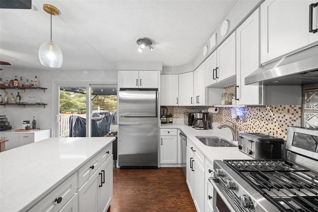 kitchen featuring light countertops, appliances with stainless steel finishes, backsplash, and open shelves