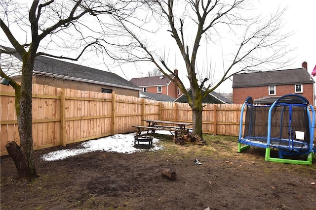 view of yard featuring a trampoline and a fenced backyard