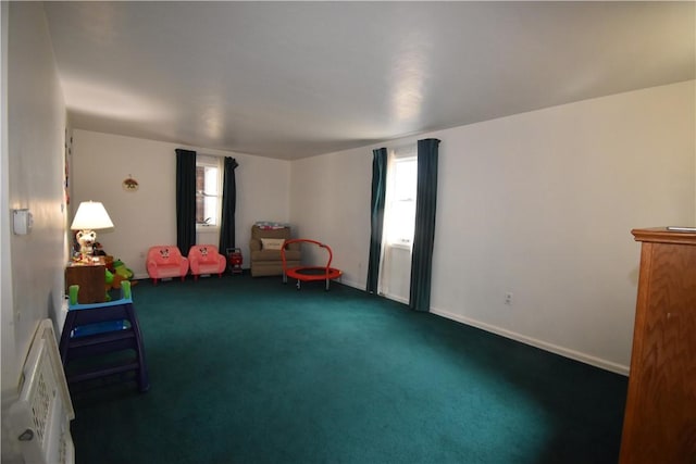 interior space featuring a wealth of natural light, baseboards, and carpet