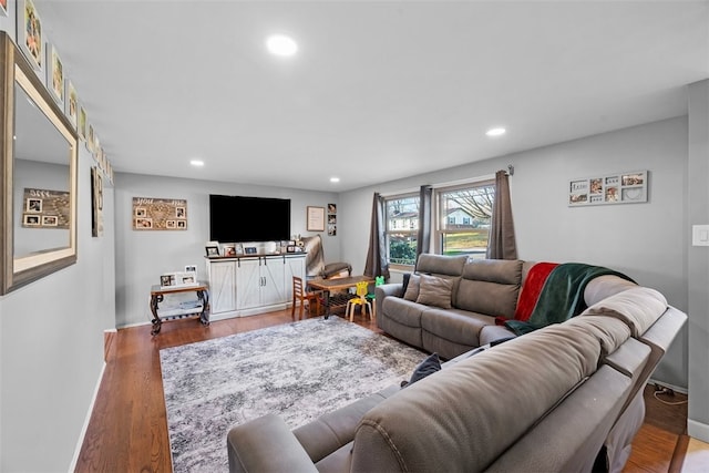 living room featuring baseboards, wood finished floors, and recessed lighting