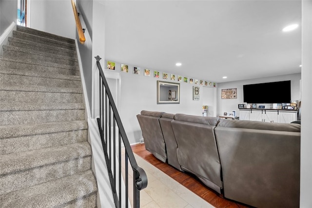 living area with stairway, wood finished floors, and recessed lighting