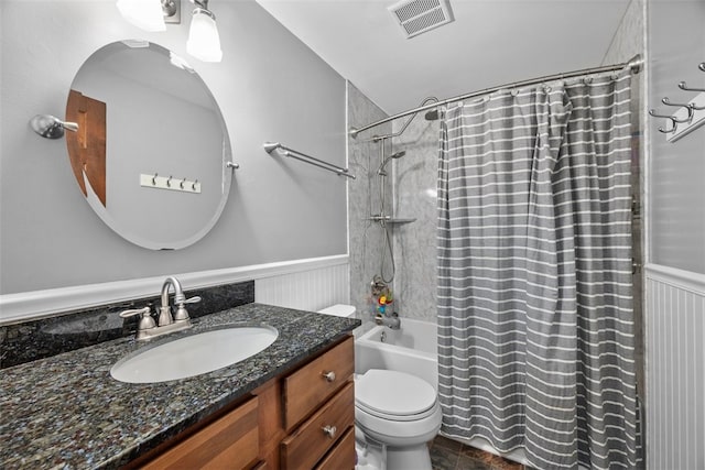 bathroom featuring a wainscoted wall, shower / bathtub combination with curtain, visible vents, and vanity