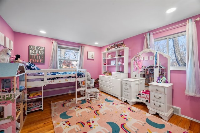 bedroom featuring light wood-type flooring, visible vents, recessed lighting, and multiple windows