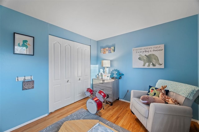 living area with baseboards and wood finished floors