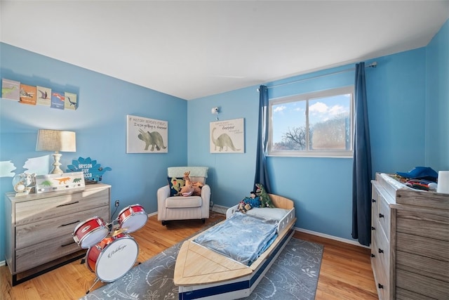 bedroom featuring wood finished floors and baseboards