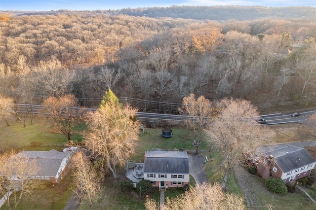 drone / aerial view featuring a forest view