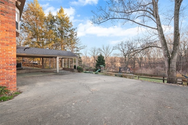 view of parking featuring aphalt driveway and an attached carport