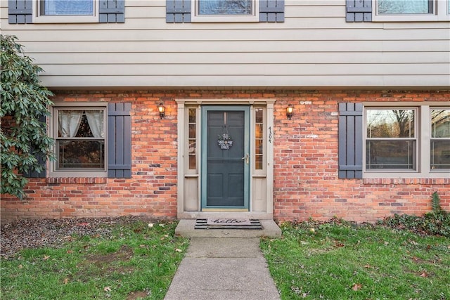 property entrance with brick siding